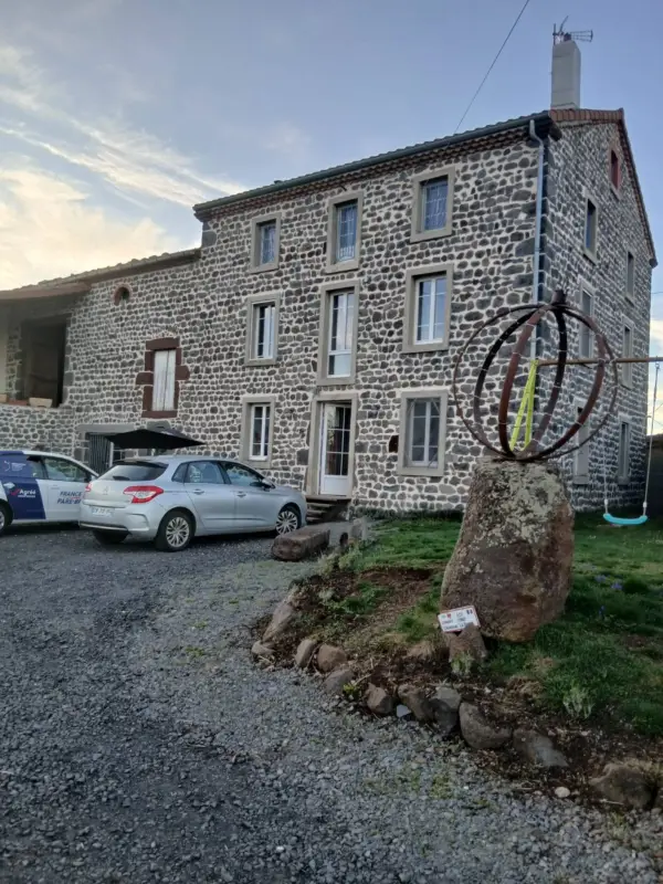 Maison en pierre avec sculpture extérieure métallique